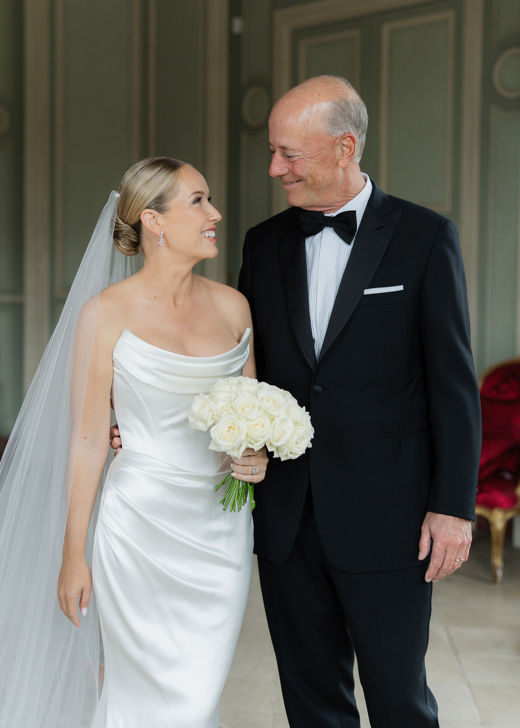 Bride getting ready with father inside Château Villette before her wedding ceremony in Paris