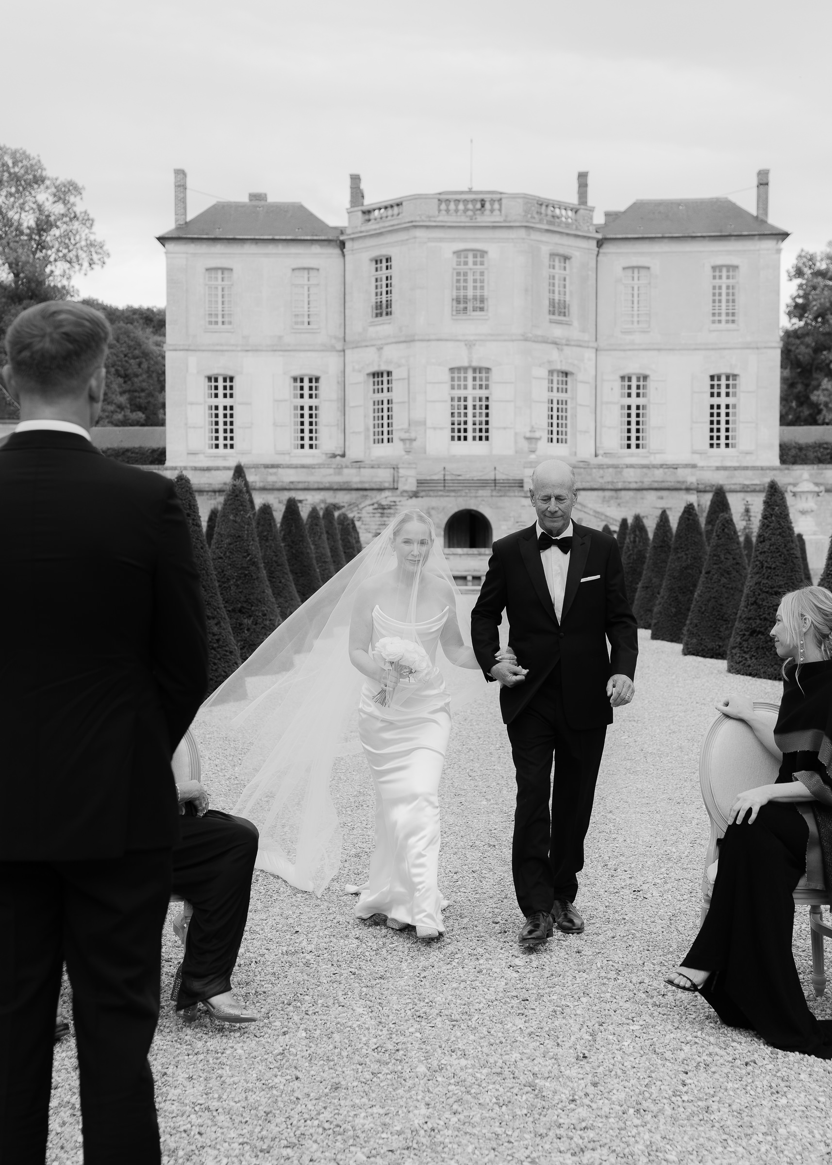 Bride walking down the aisle with father at Château Villette intimate wedding in Paris