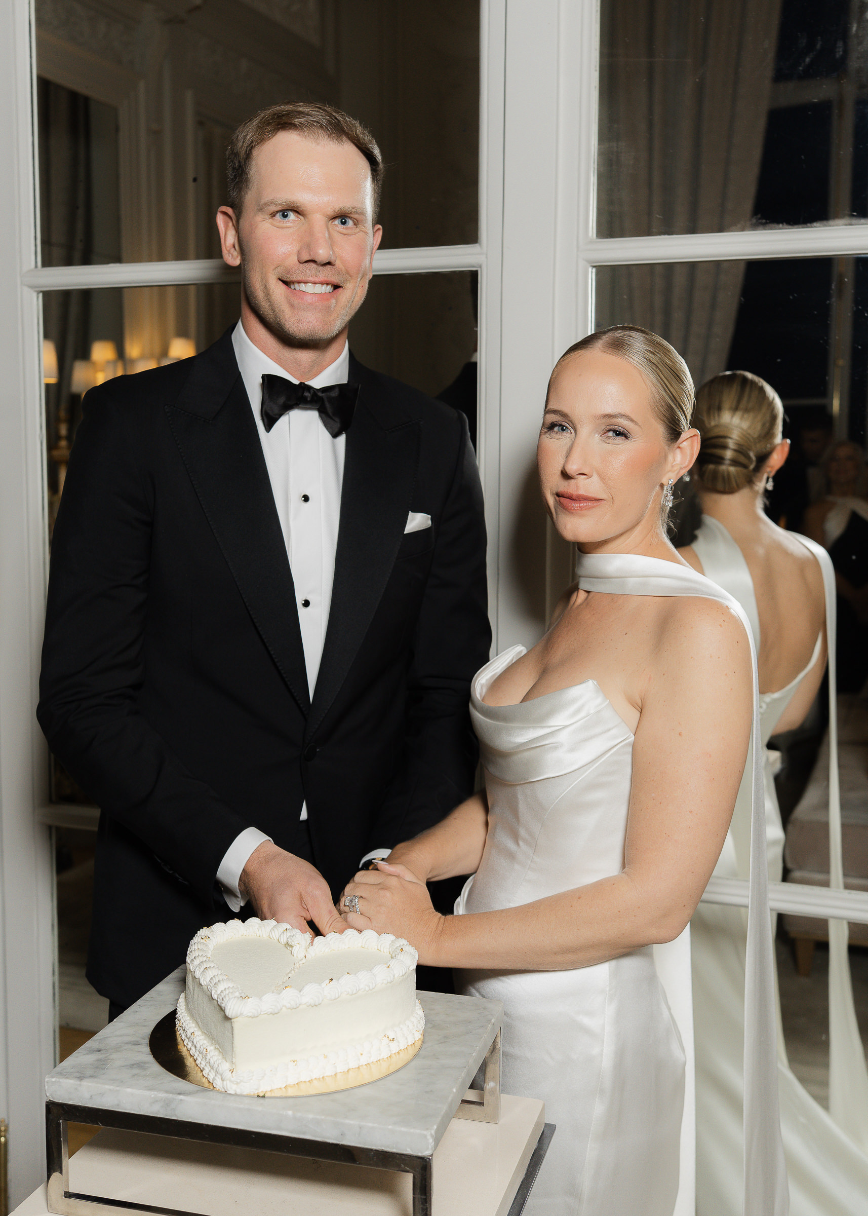 Bride and groom cutting cake at Hôtel de Crillon Paris wedding reception