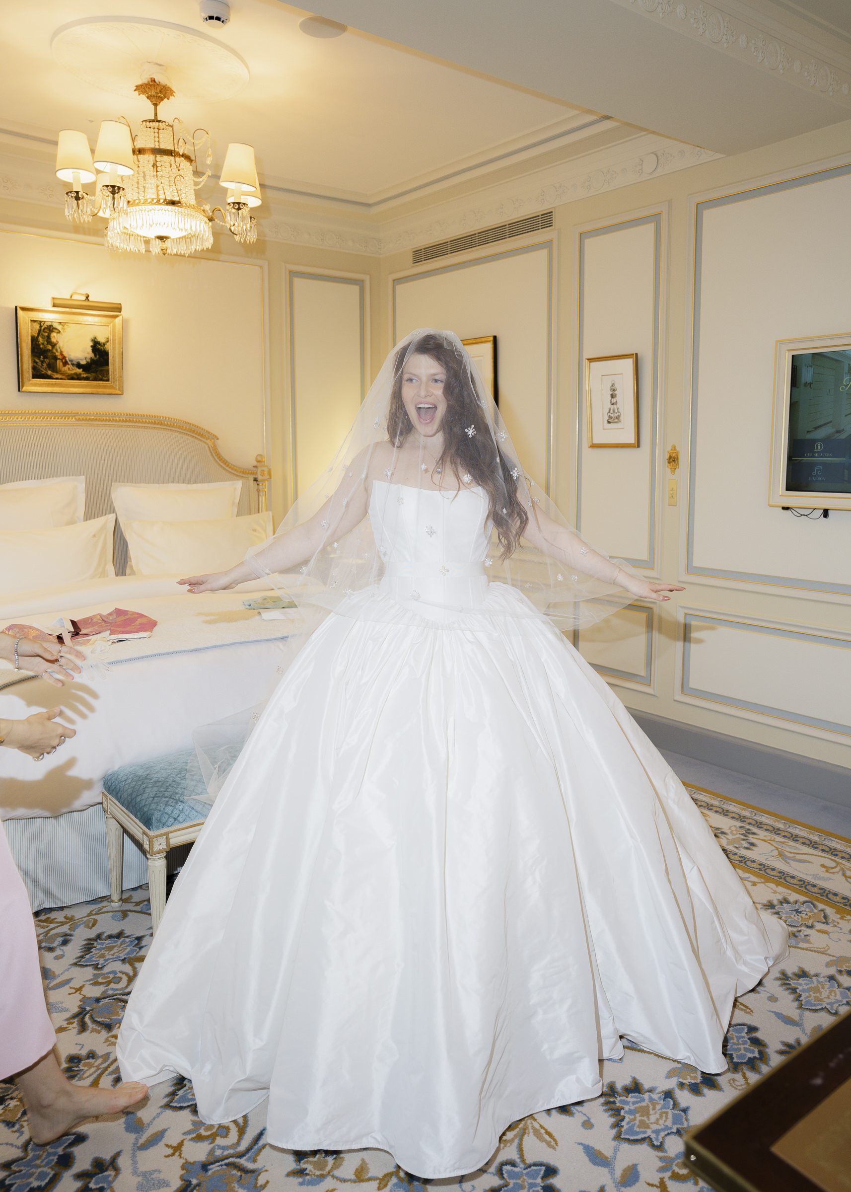 Bride putting on her dress before her intimate Paris wedding