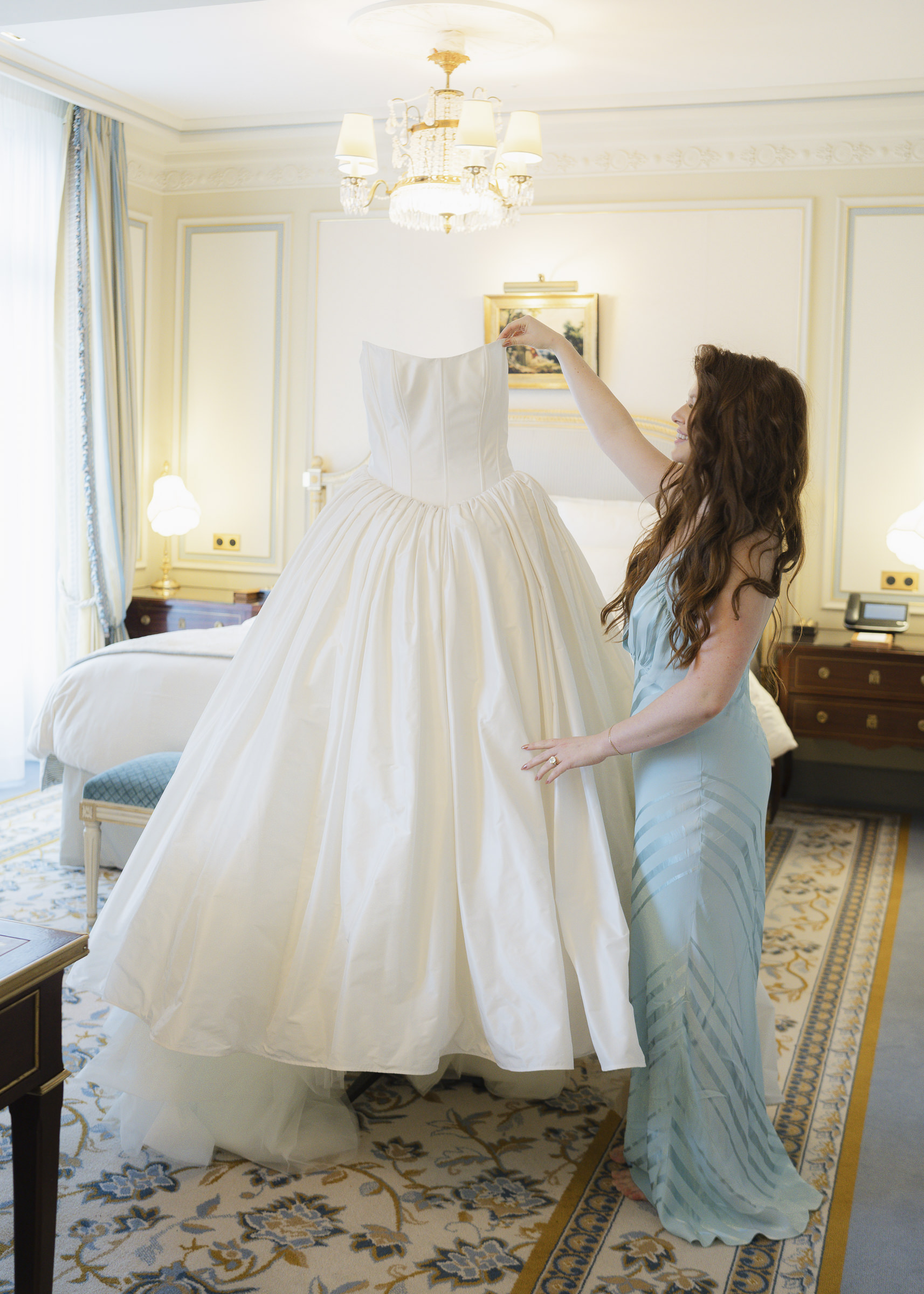 Bride putting on her dress before her intimate Paris wedding