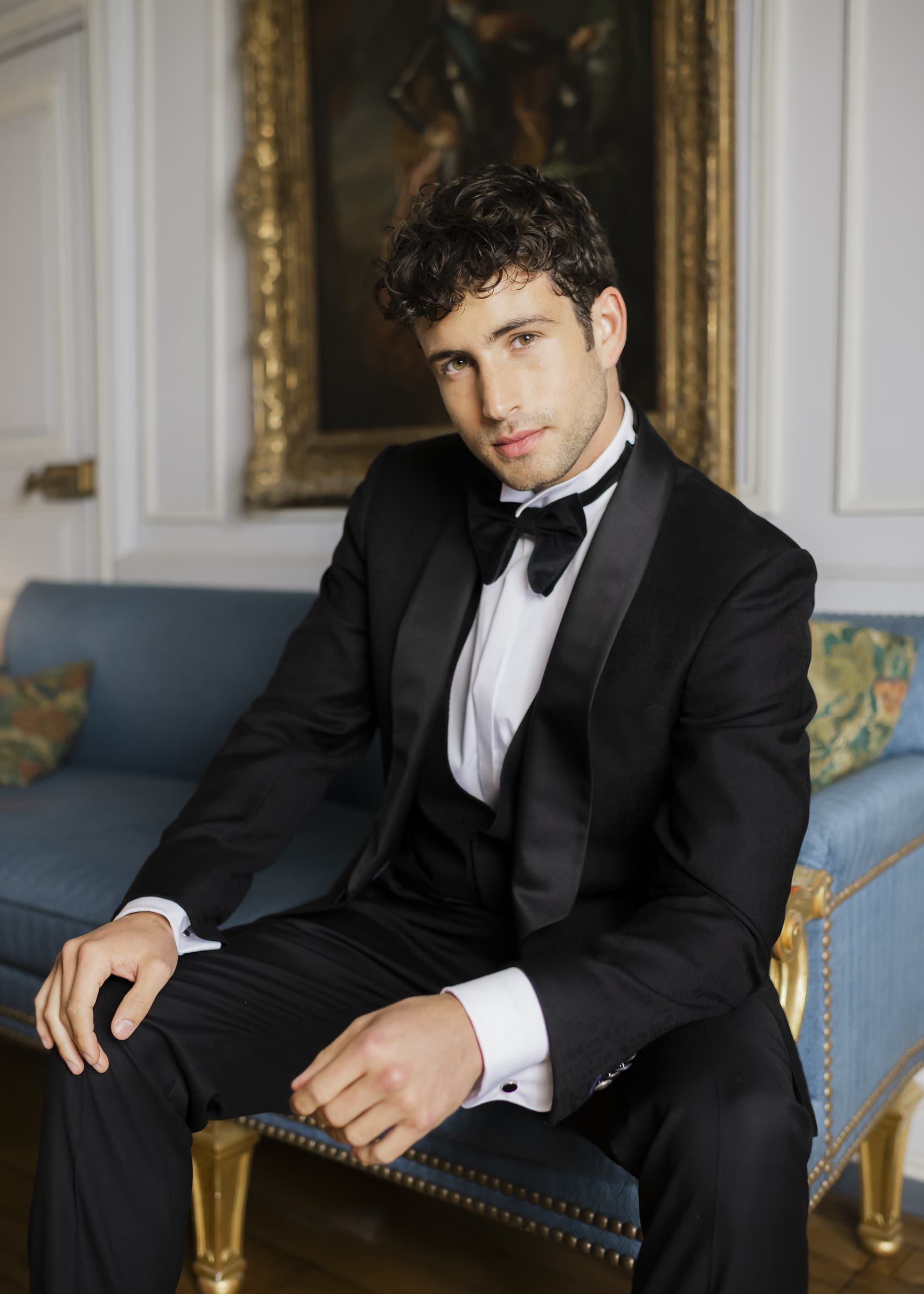 Fashion-led groom portrait in an elegant château interior