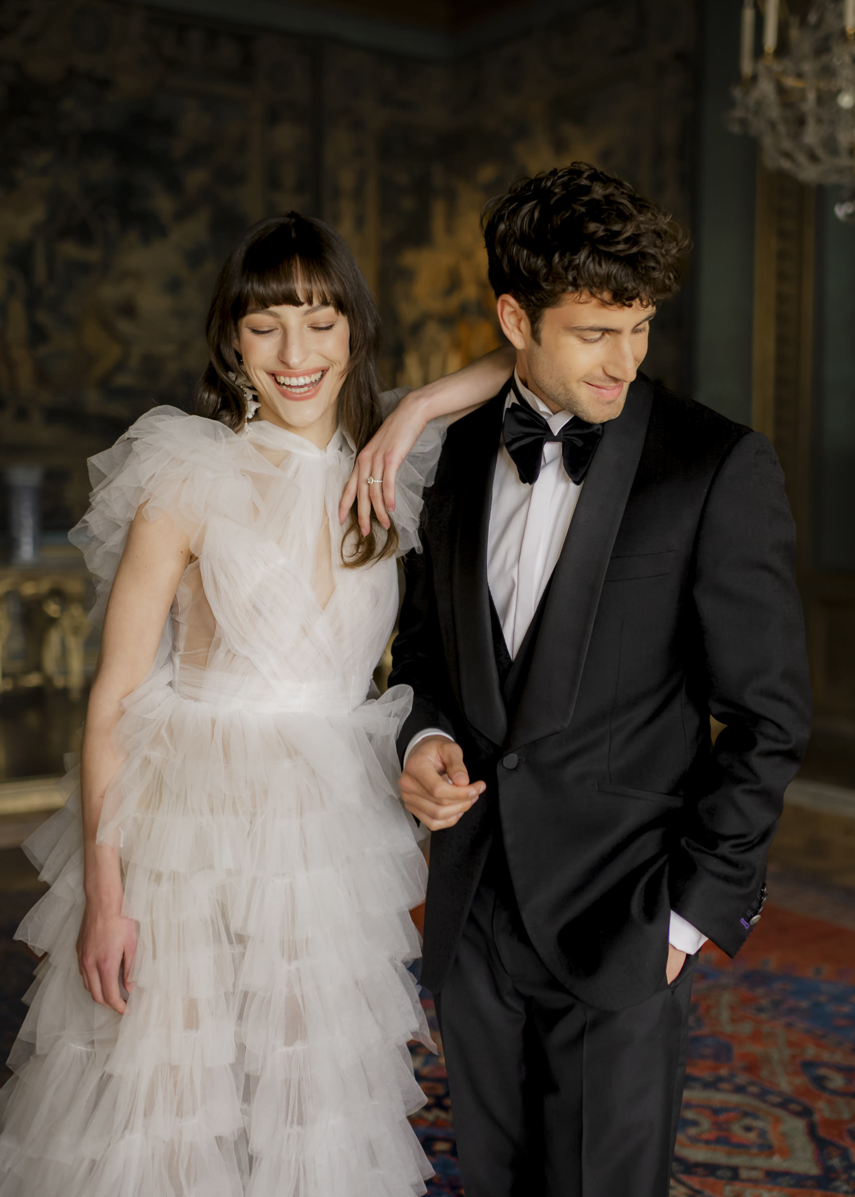 Fun editorial portrait of bride and groom showcasing the grandeur of a historic château setting