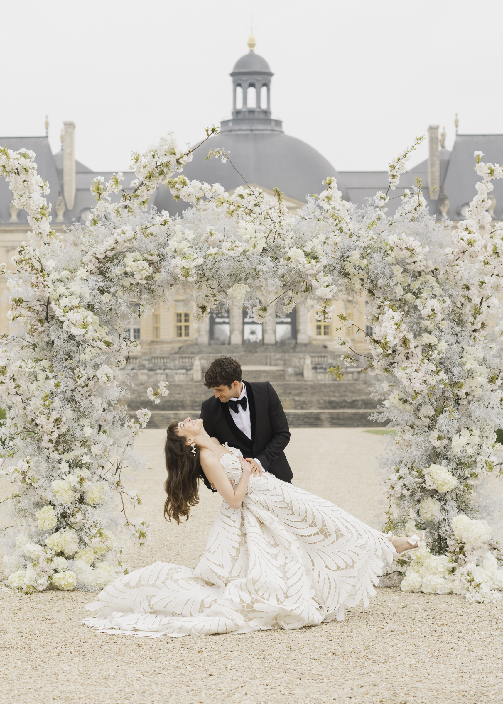 Bride and groom sharing their first kiss at their château wedding ceremony