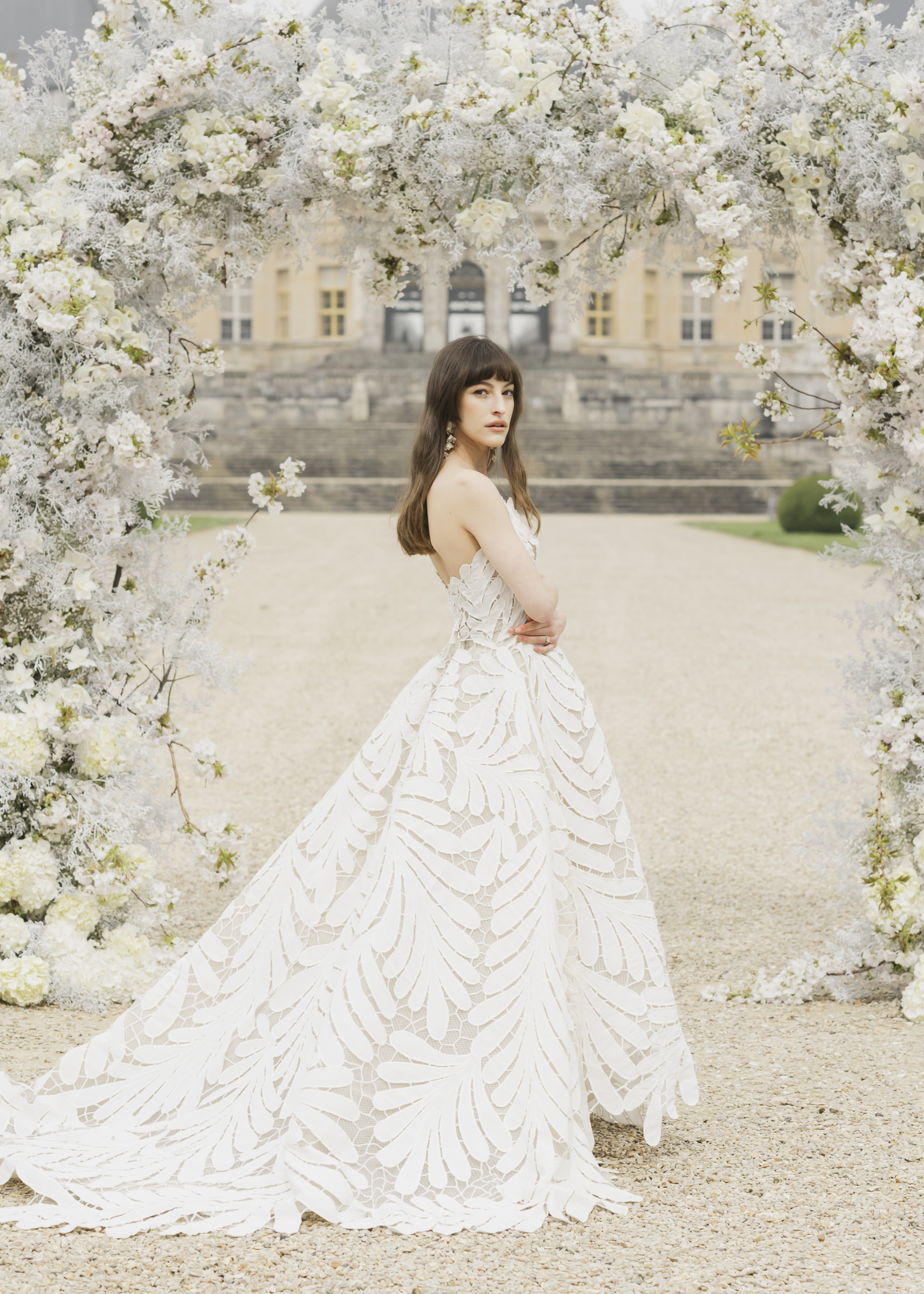 Bride posed in a refined wedding portrait at a French château