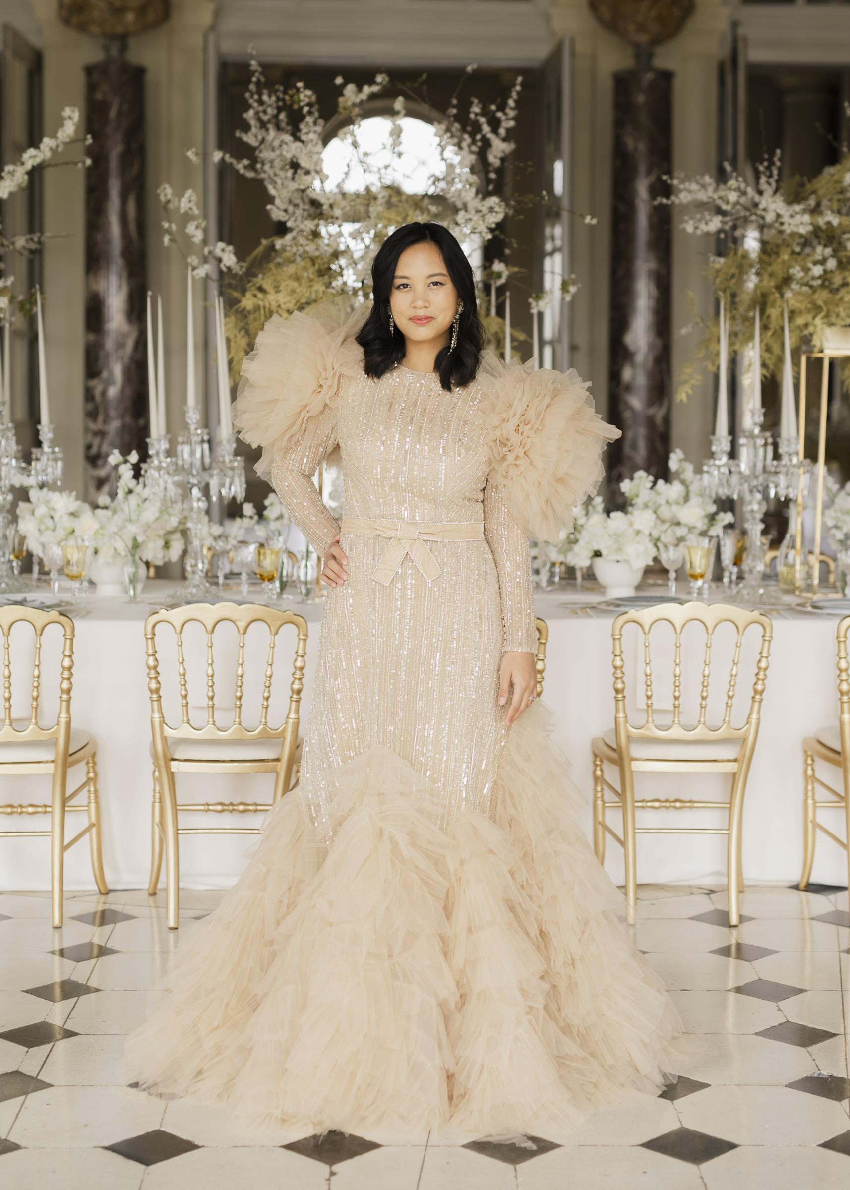 Bridesmaid wearing high-fashion designer dresses at a luxury château wedding