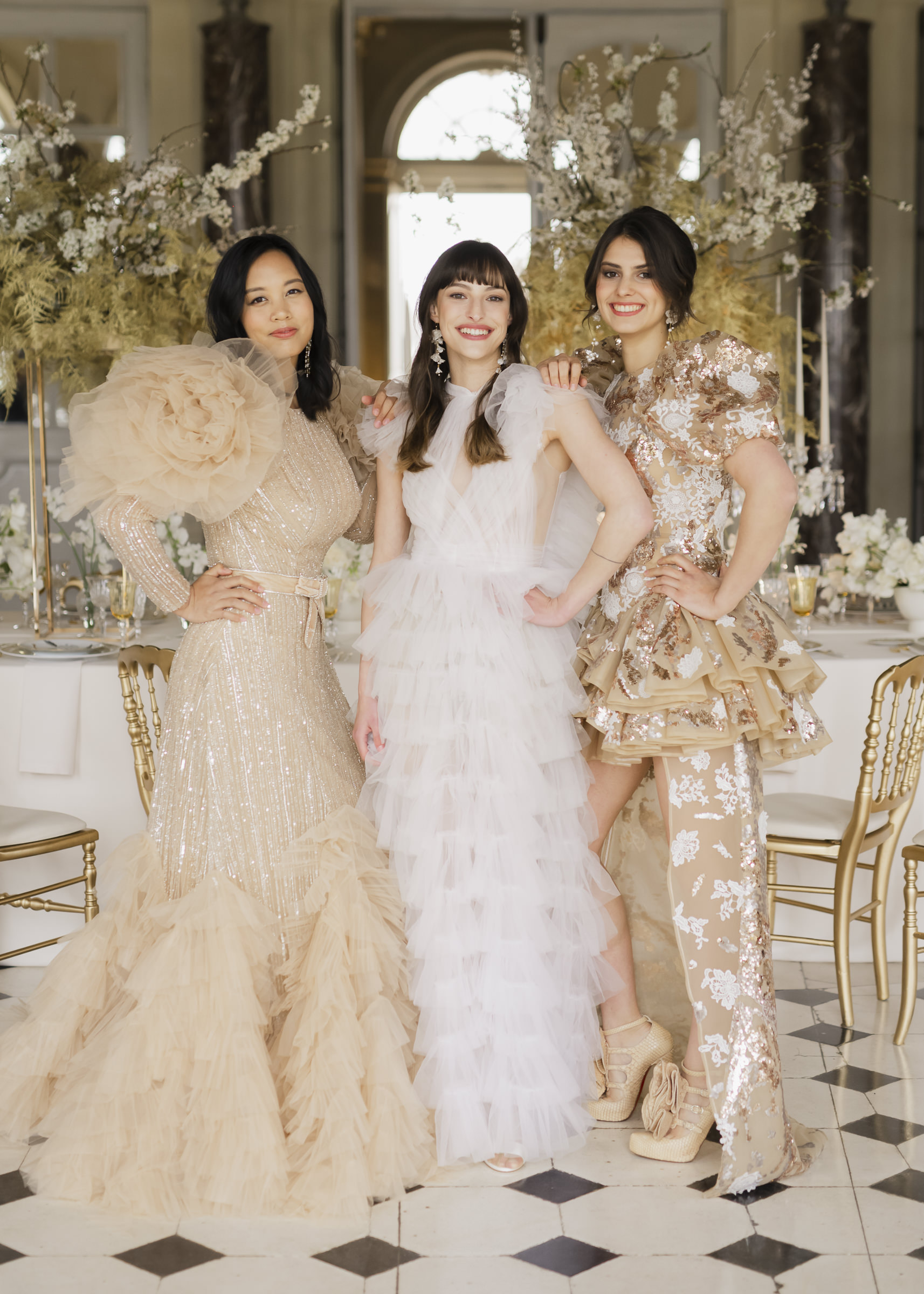 Bride with bridesmaids styled in high-fashion dresses at Château de Vaux-le-Vicomte