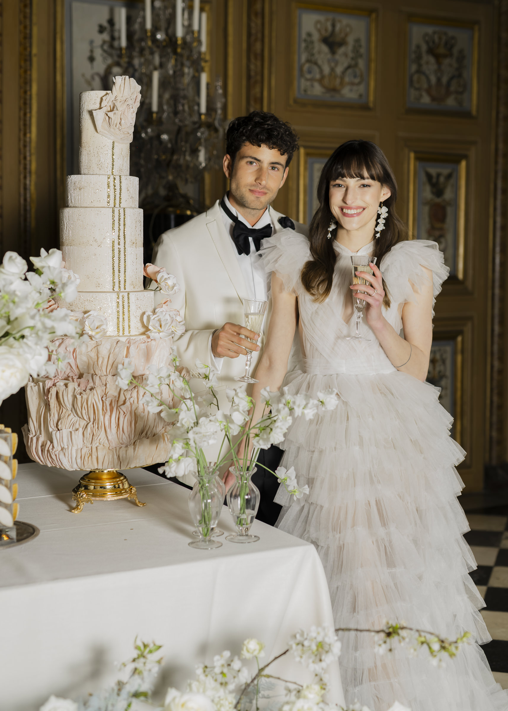 Bride and groom sharing a refined cake cutting moment in a French château