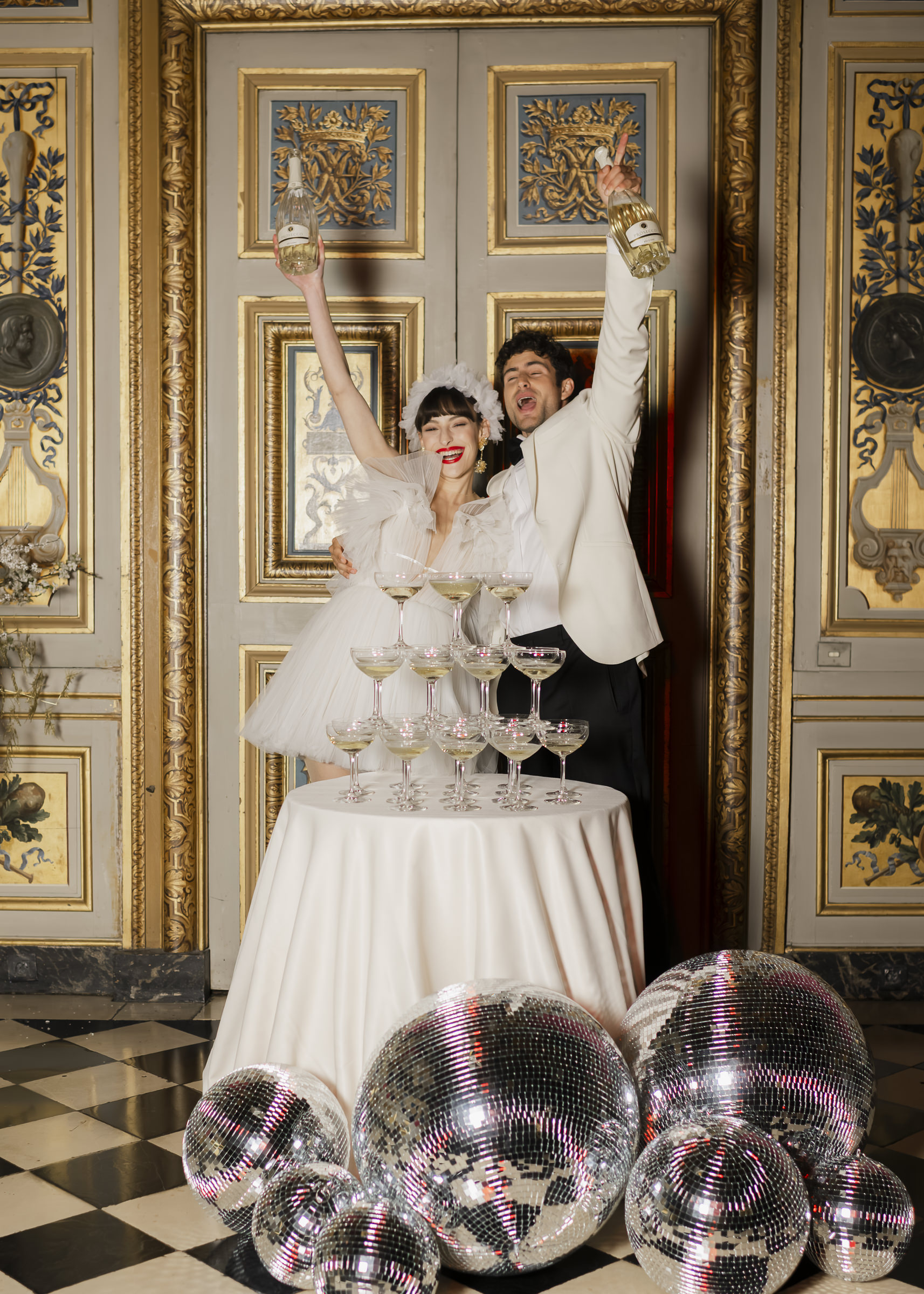 Luxury château wedding party as night falls at Vaux-le-Vicomte, Champagne Tower moments with Bride and Groom,