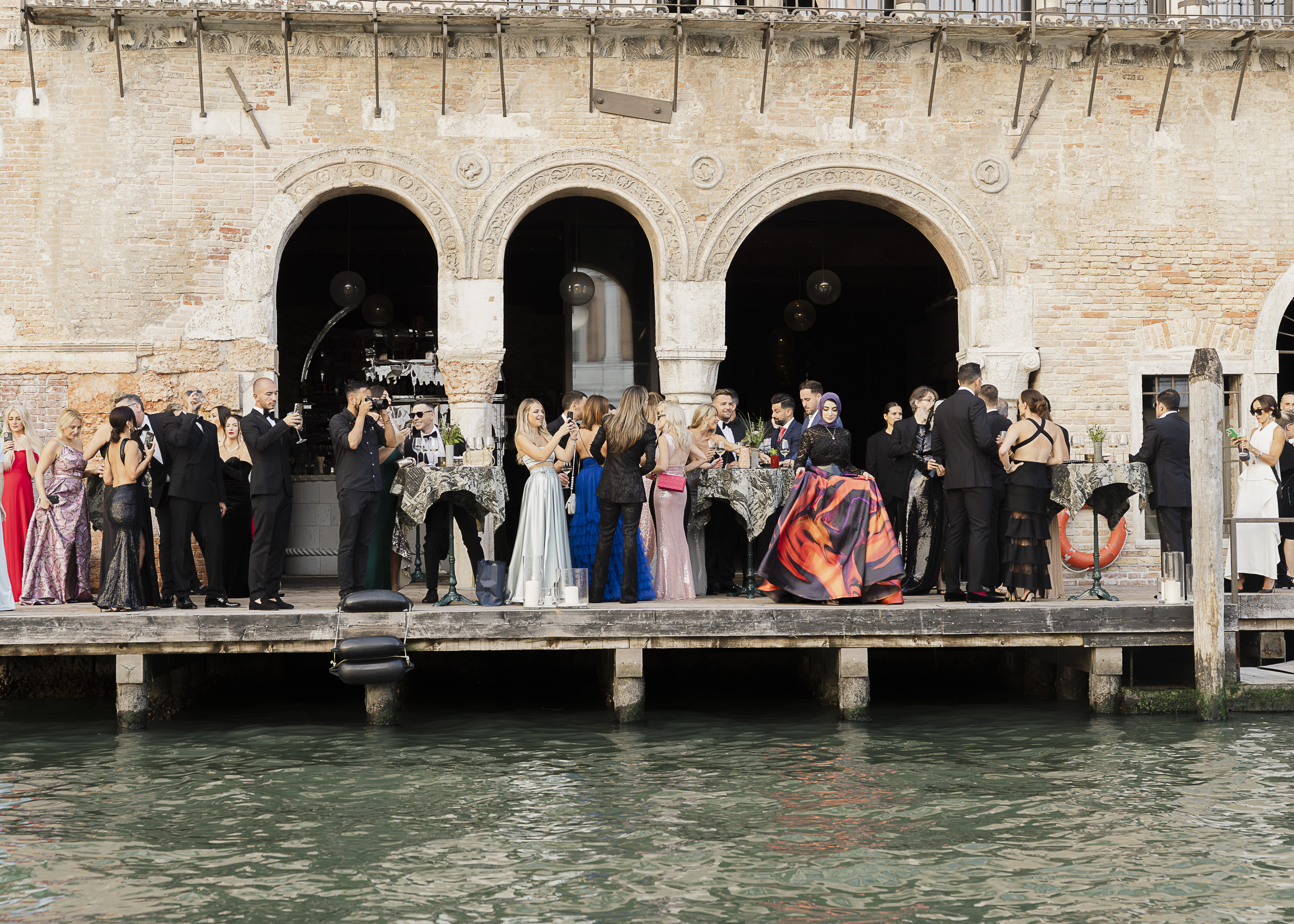 Guests awaiting the guest of honour beside the canal at Venice Venice Hotel