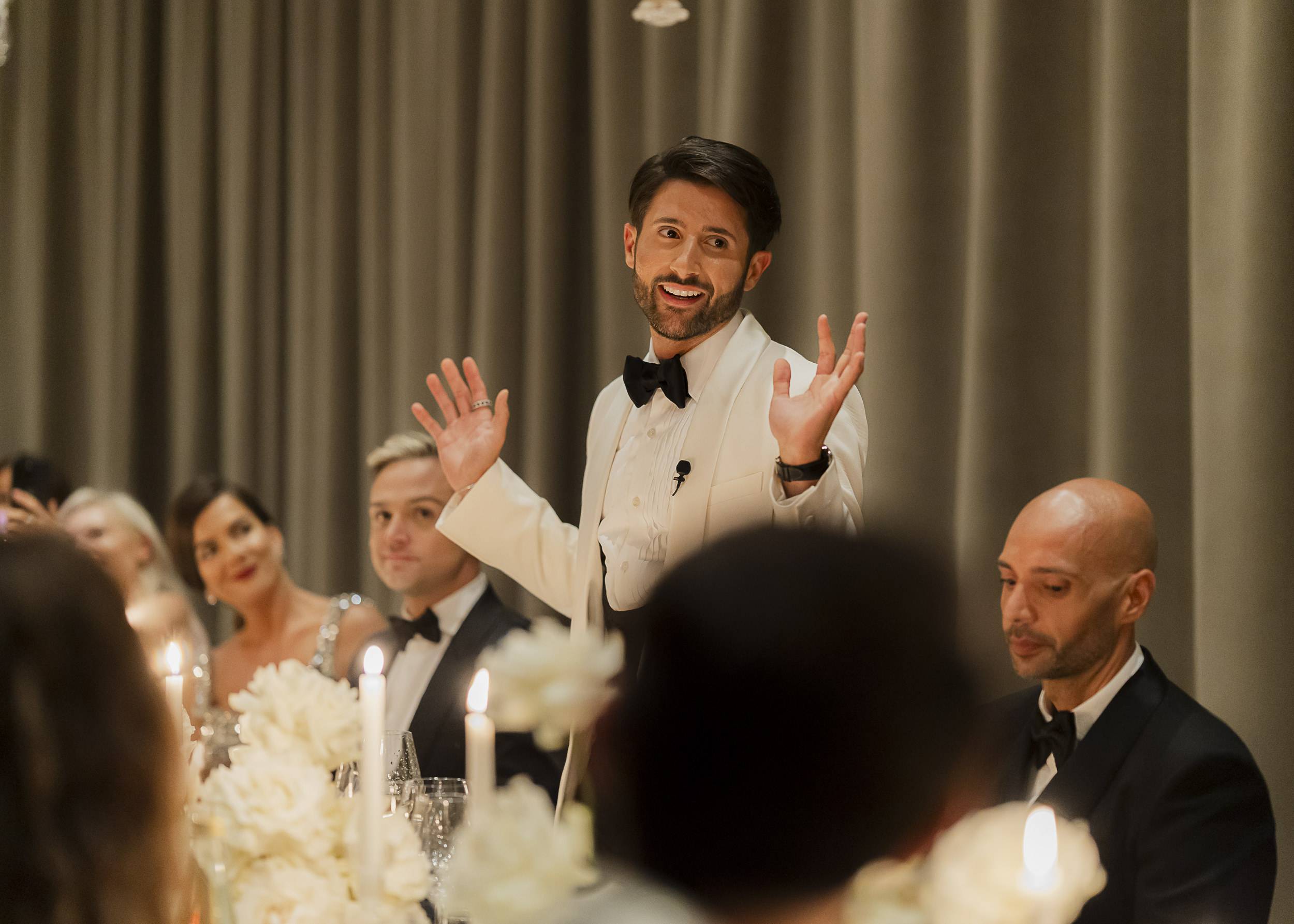 Speech moment in a candlelit dining room in Venice