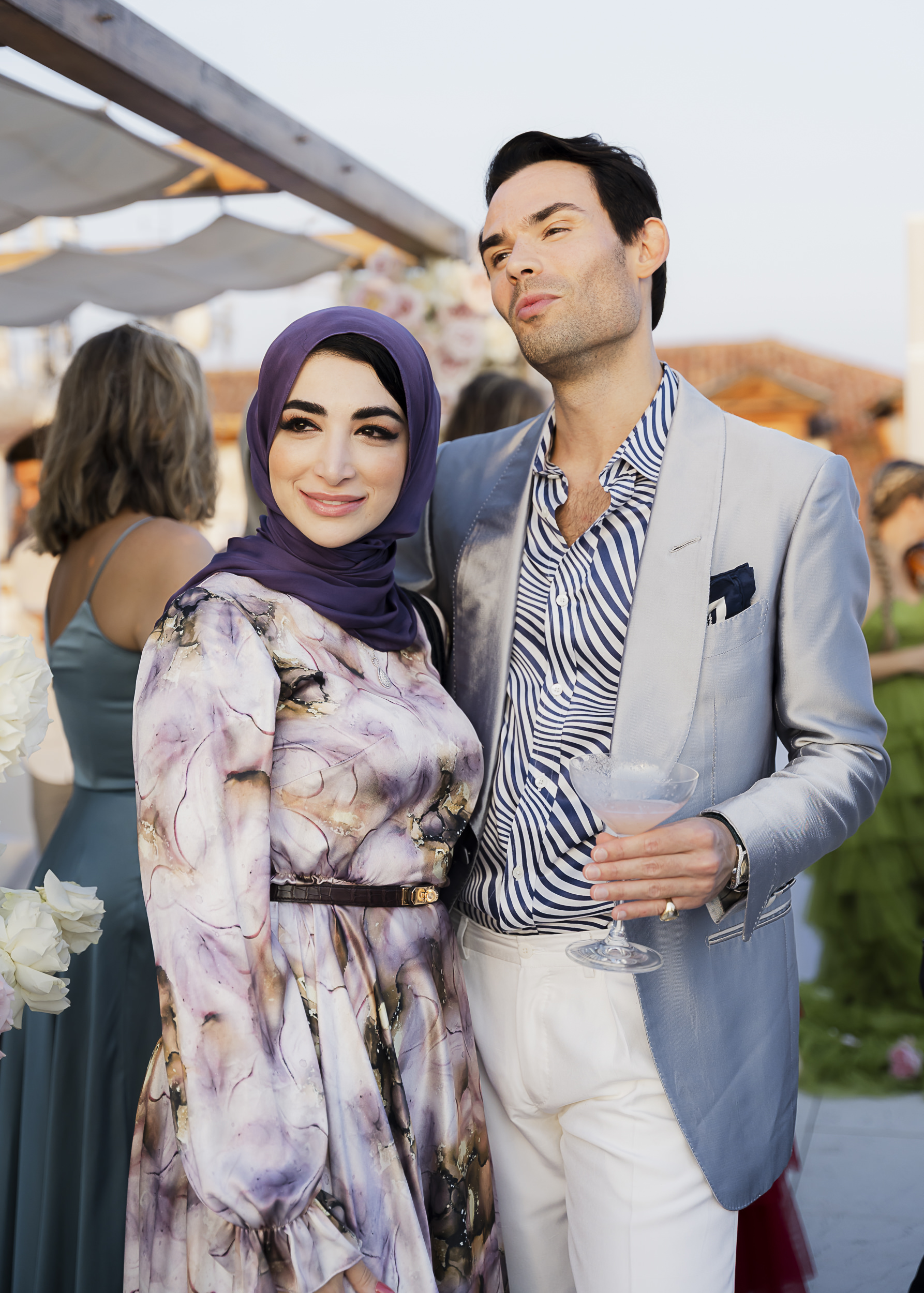 Candid moments of guests gathering on a terrace overlooking the Grand Canal