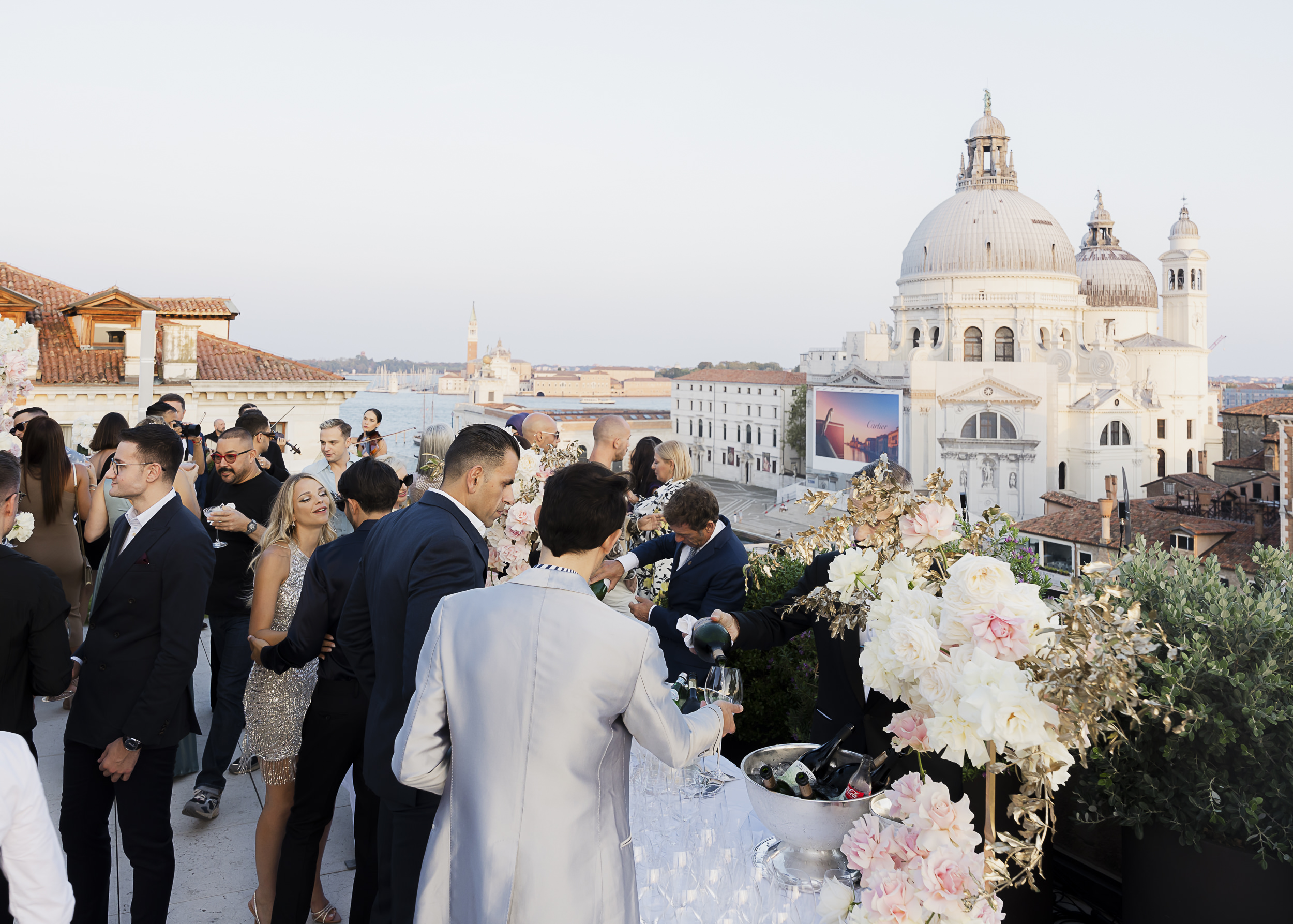 Evening drinks on a rooftop terrace in Venice overlooking the canal